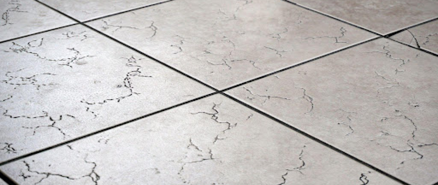 Cracked floor tile caused by poor tile installation and weak adhesive bonding.