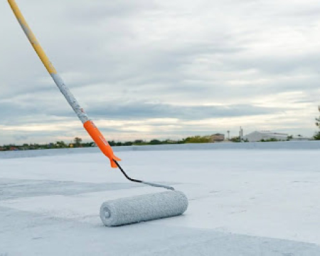 Worker applying VURA waterproofing solution to protect a building from water leakage and moisture damage.