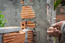 AAC block adhesive application during modern lightweight block wall construction