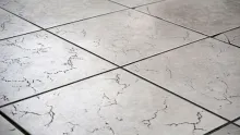Cracked floor tile caused by poor tile installation and weak adhesive bonding.