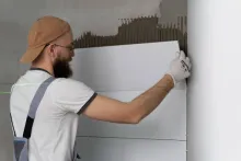 Professional installing ceramic floor tiles using VURA premium tile adhesive for strong and durable bonding.